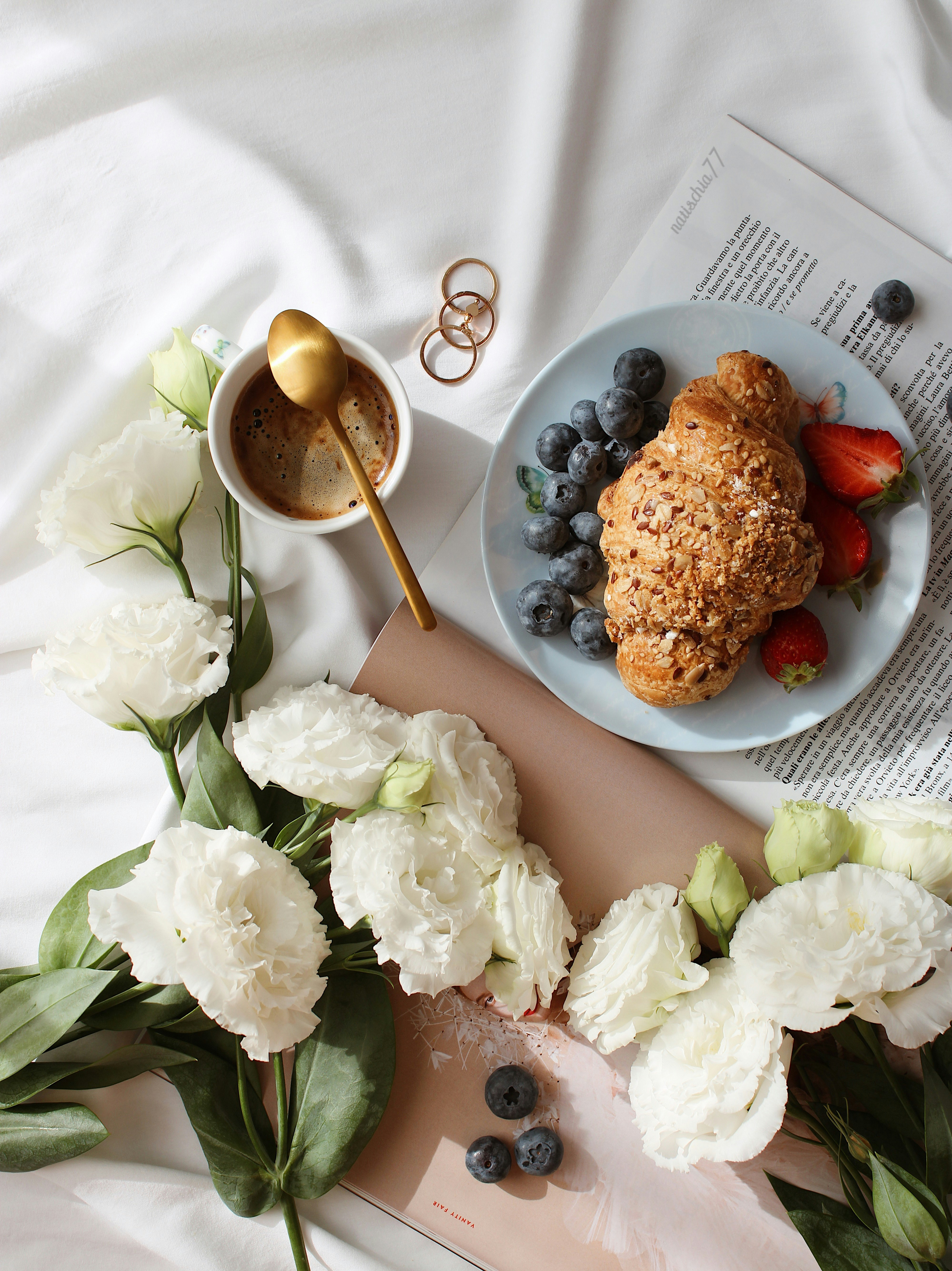 white roses beside brown wooden spoon